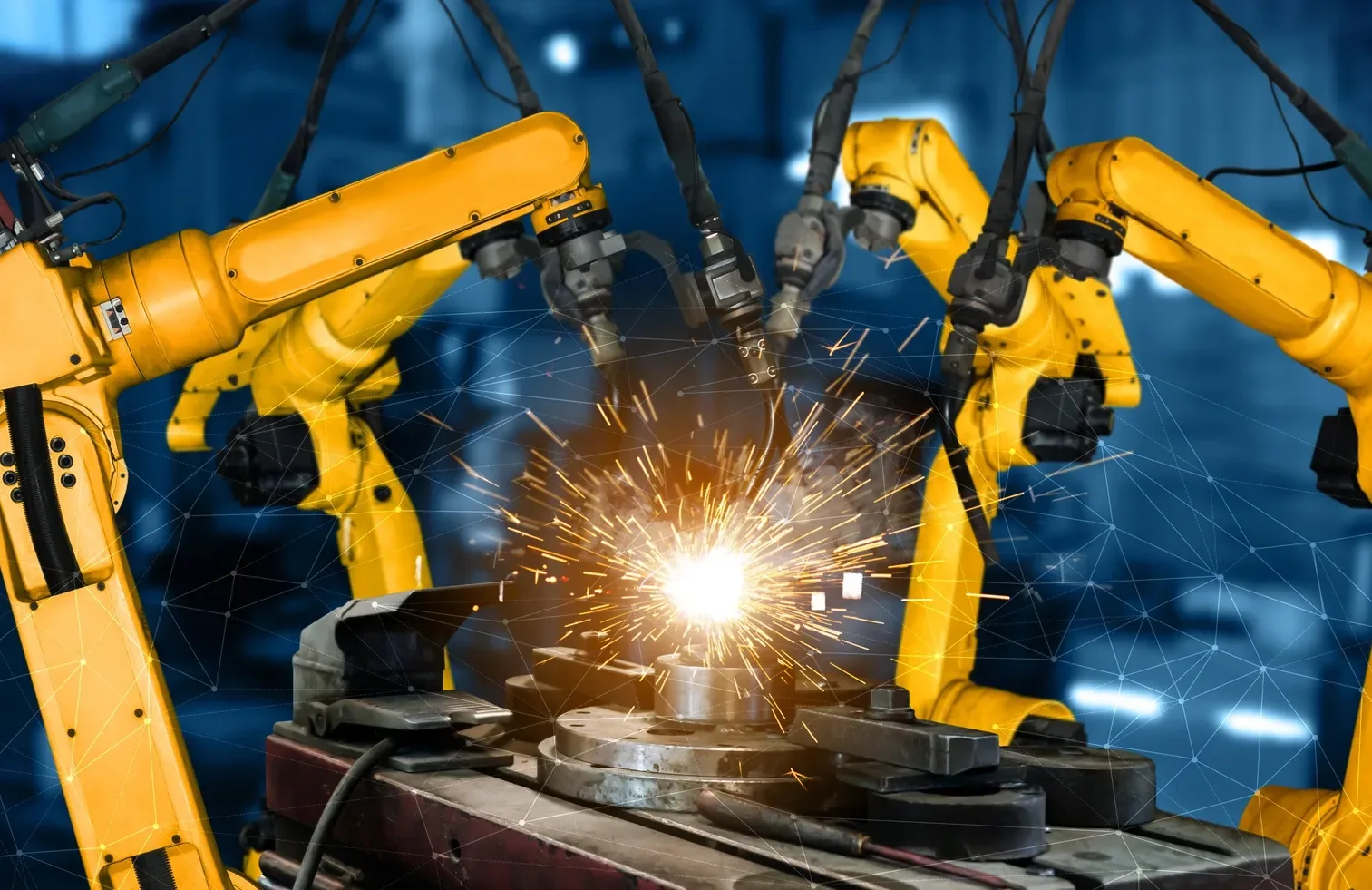 Robotic welding arms in an automated production cell