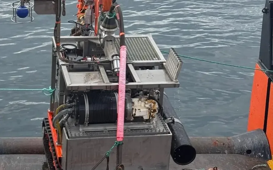 The Raptor Scout tracked ROV on the deck of a multicat at Dounreay, rigged with suction dredging equipment before deployment